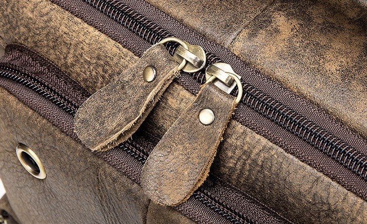 Rossie Viren vintage crossbody handbag with two front pockets, grab handle, and long shoulder strap.