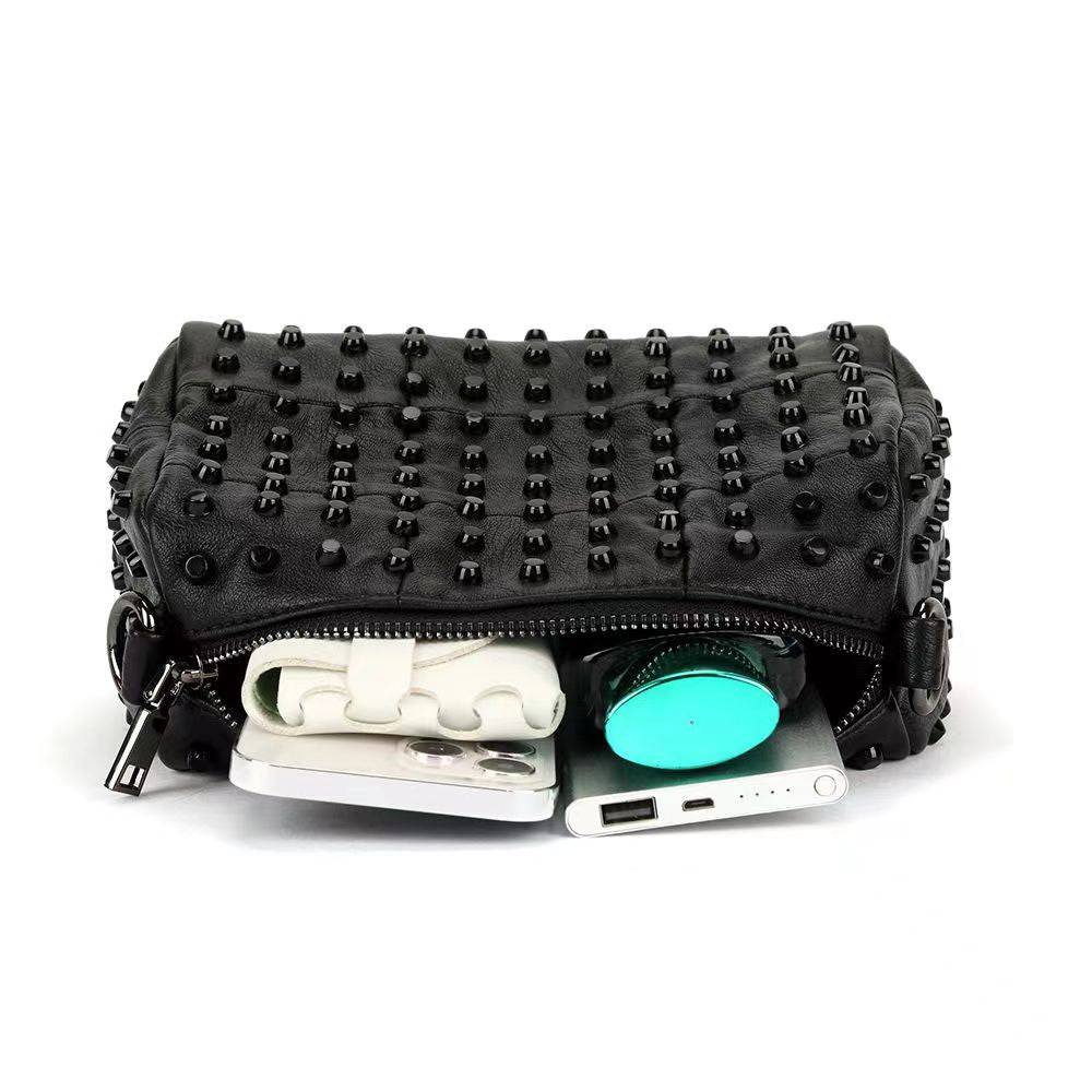 Rossie Viren women's studded satchel shoulder bag with top handle and adjustable strap, featuring studded detailing and spacious interior.