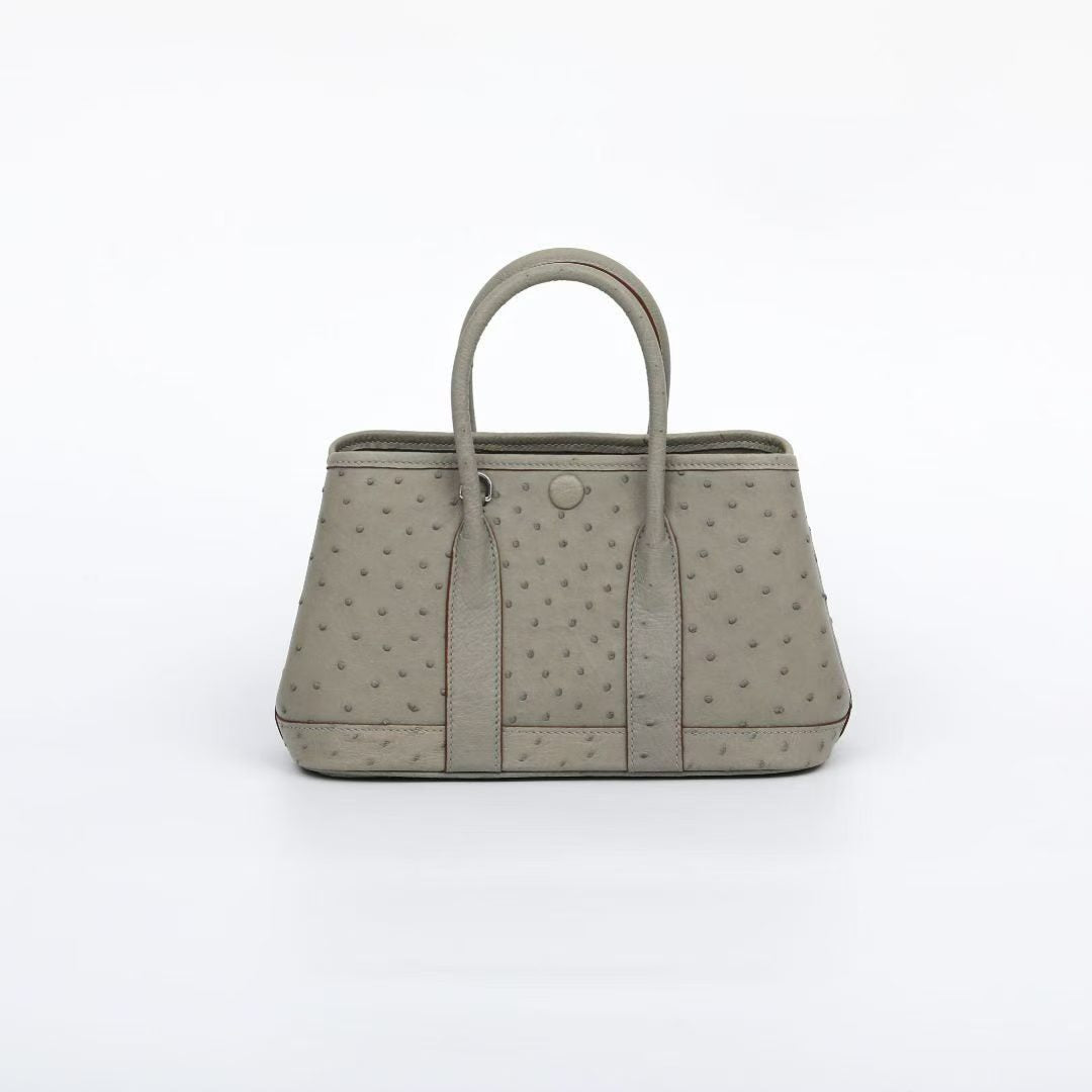 Genuine ostrich skin leather small tote handbag by Rossie Viren with top handles and sleek design.