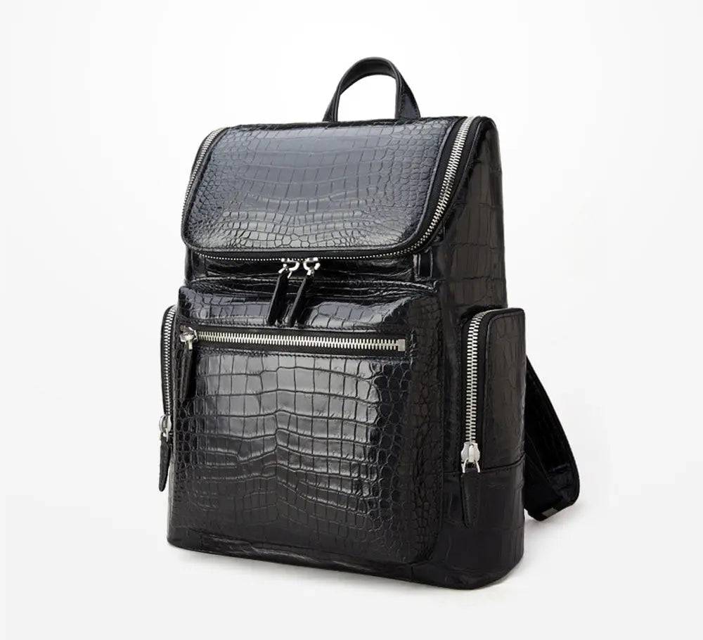 Black crocodile leather backpack by Rossie Viren with sleek design and sturdy straps, featuring textured crocodile pattern and spacious interior.