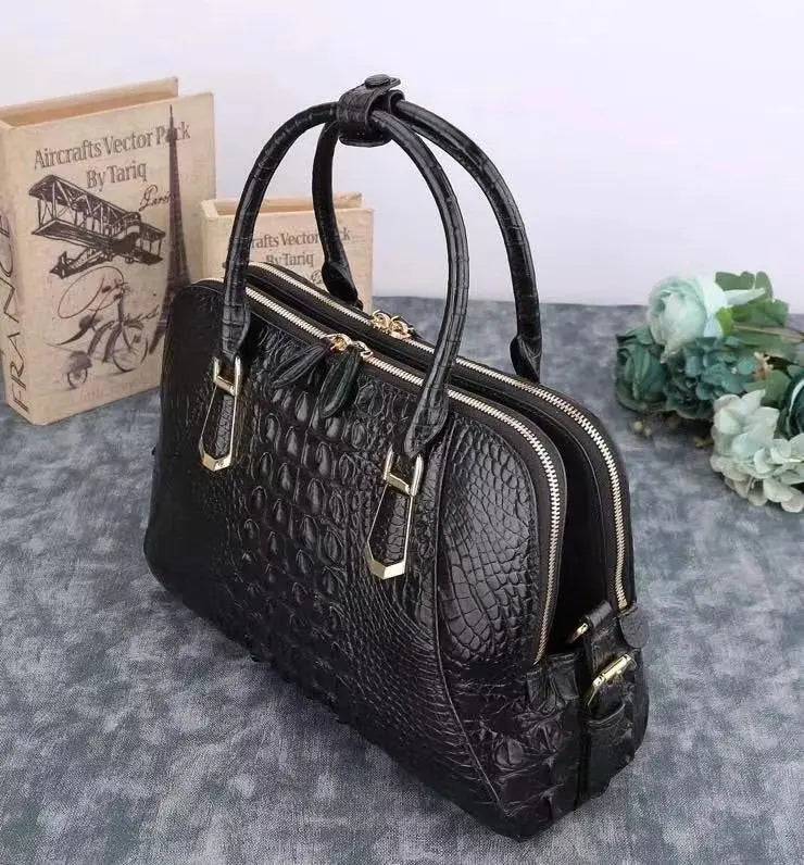 Black crocodile leather briefcase handbag with shell-style design by Rossie Viren, featuring a textured crocodile pattern and sturdy handle.
