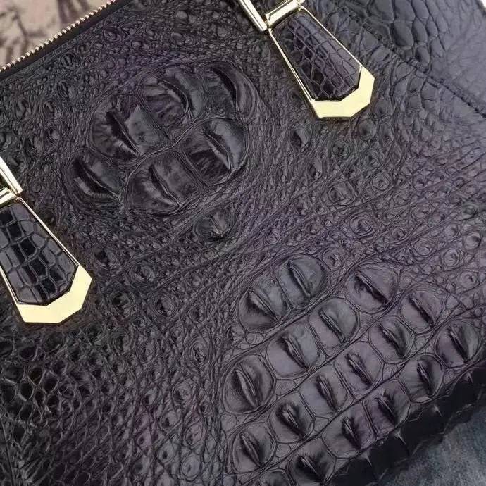 Black crocodile leather briefcase handbag by Rossie Viren with shell-style textured leather and sturdy handles.