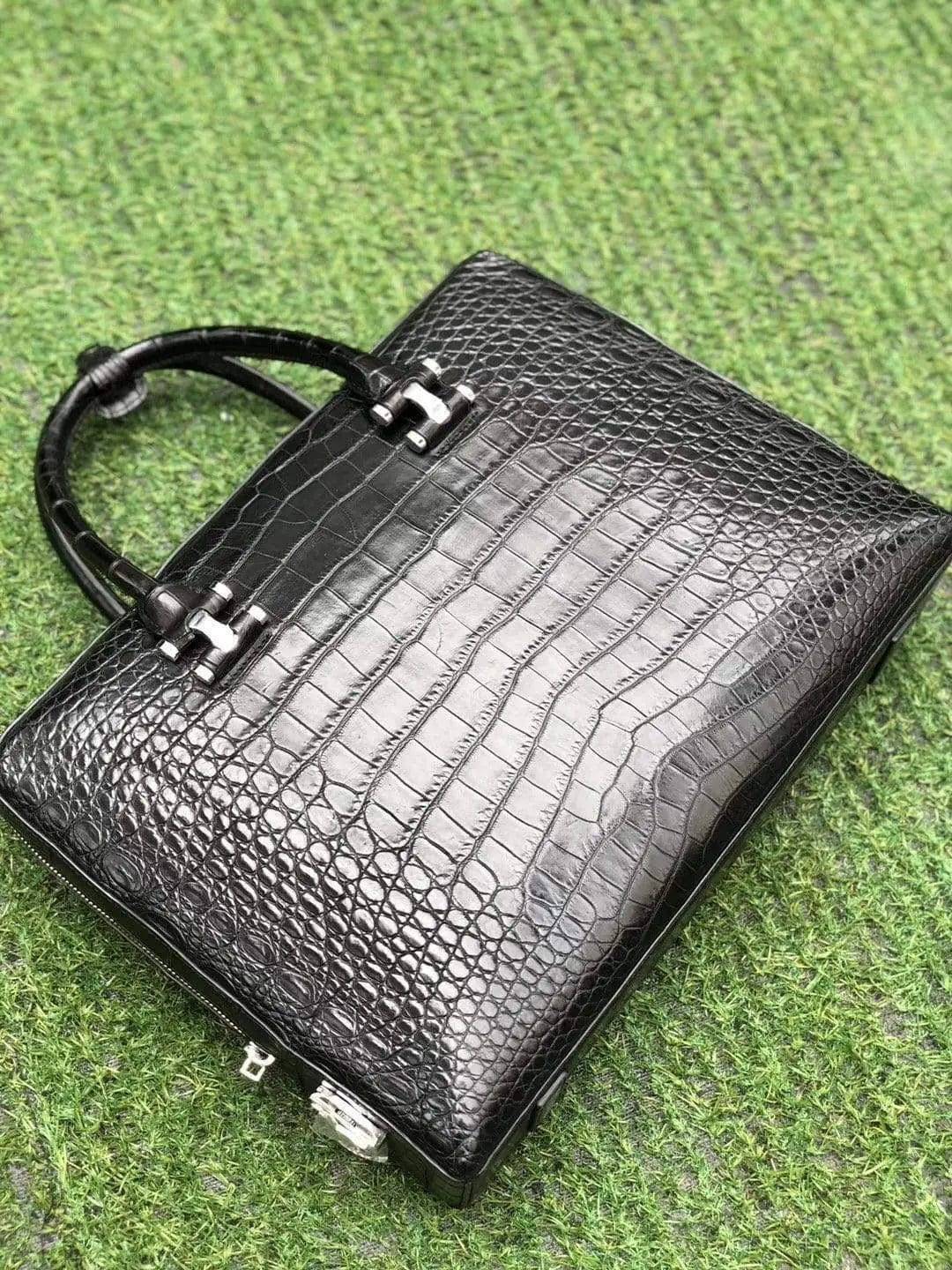 Black genuine crocodile leather briefcase by Rossie Viren with side password lock, featuring a sleek, textured crocodile pattern.