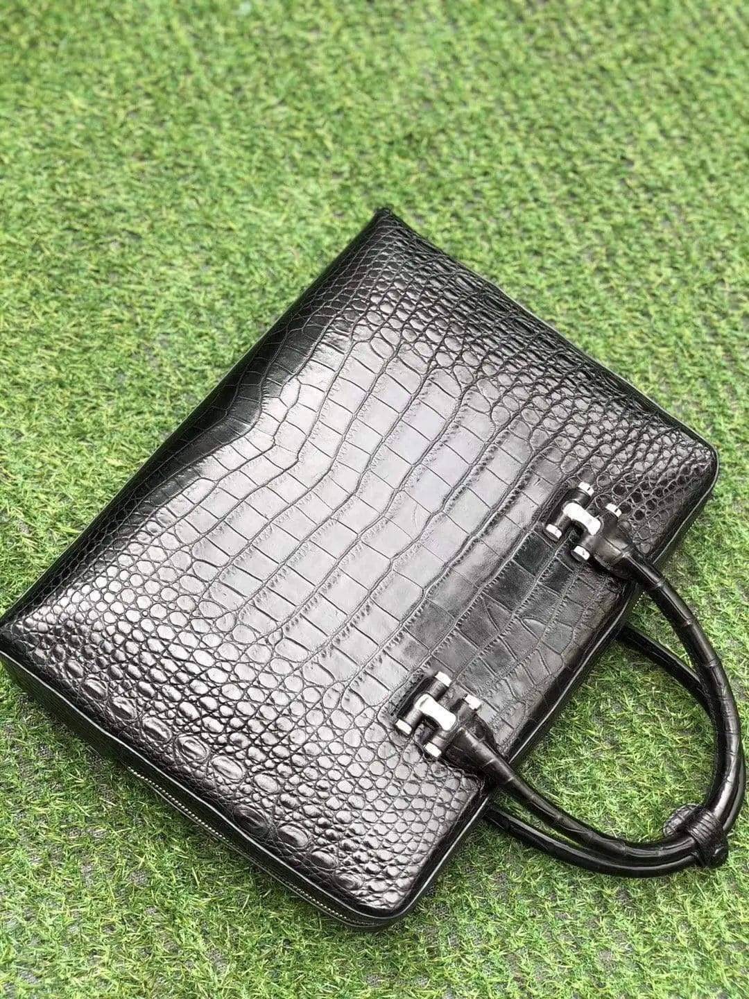Black genuine crocodile leather briefcase with side password lock, designed by Rossie Viren, featuring a sleek and luxurious appearance.