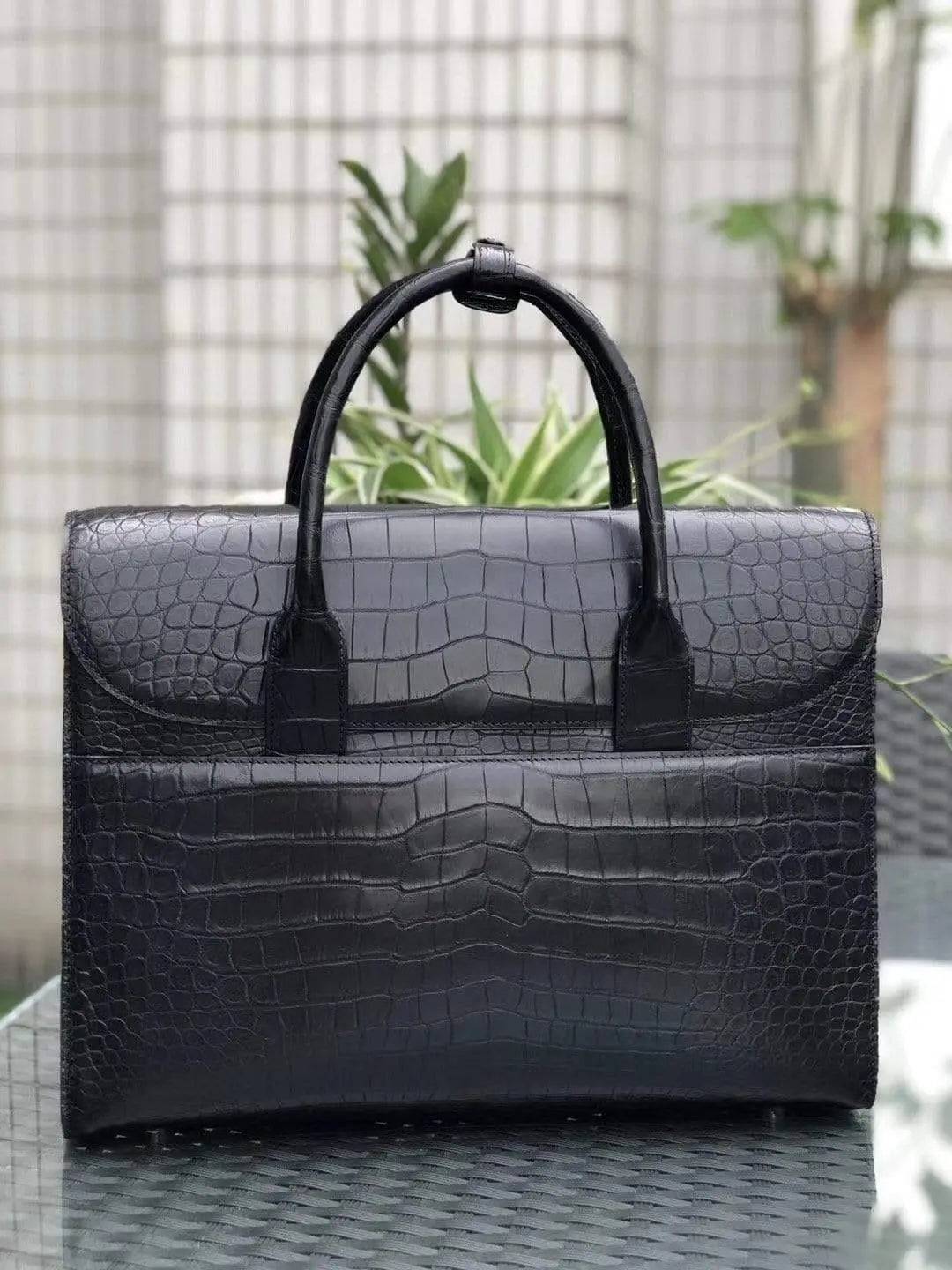 Black genuine crocodile leather foldover briefcase by Rossie Viren with textured crocodile pattern and sleek professional design.