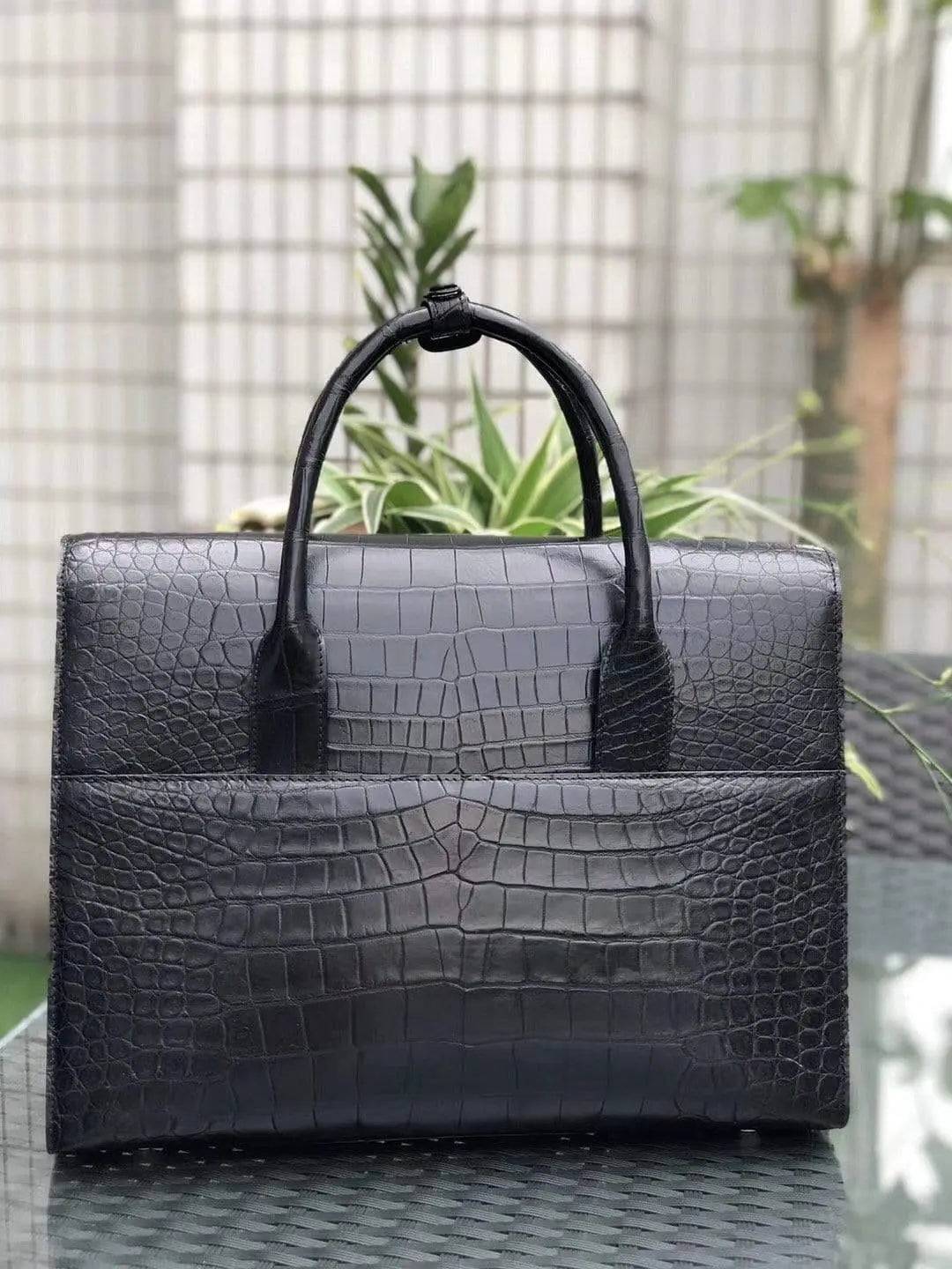 Black genuine crocodile leather foldover briefcase by Rossie Viren with textured crocodile pattern and sturdy handles.