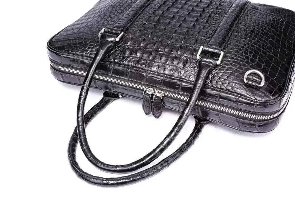 Black Rossie Viren crocodile leather travel laptop briefcase with sturdy handle and sleek design.