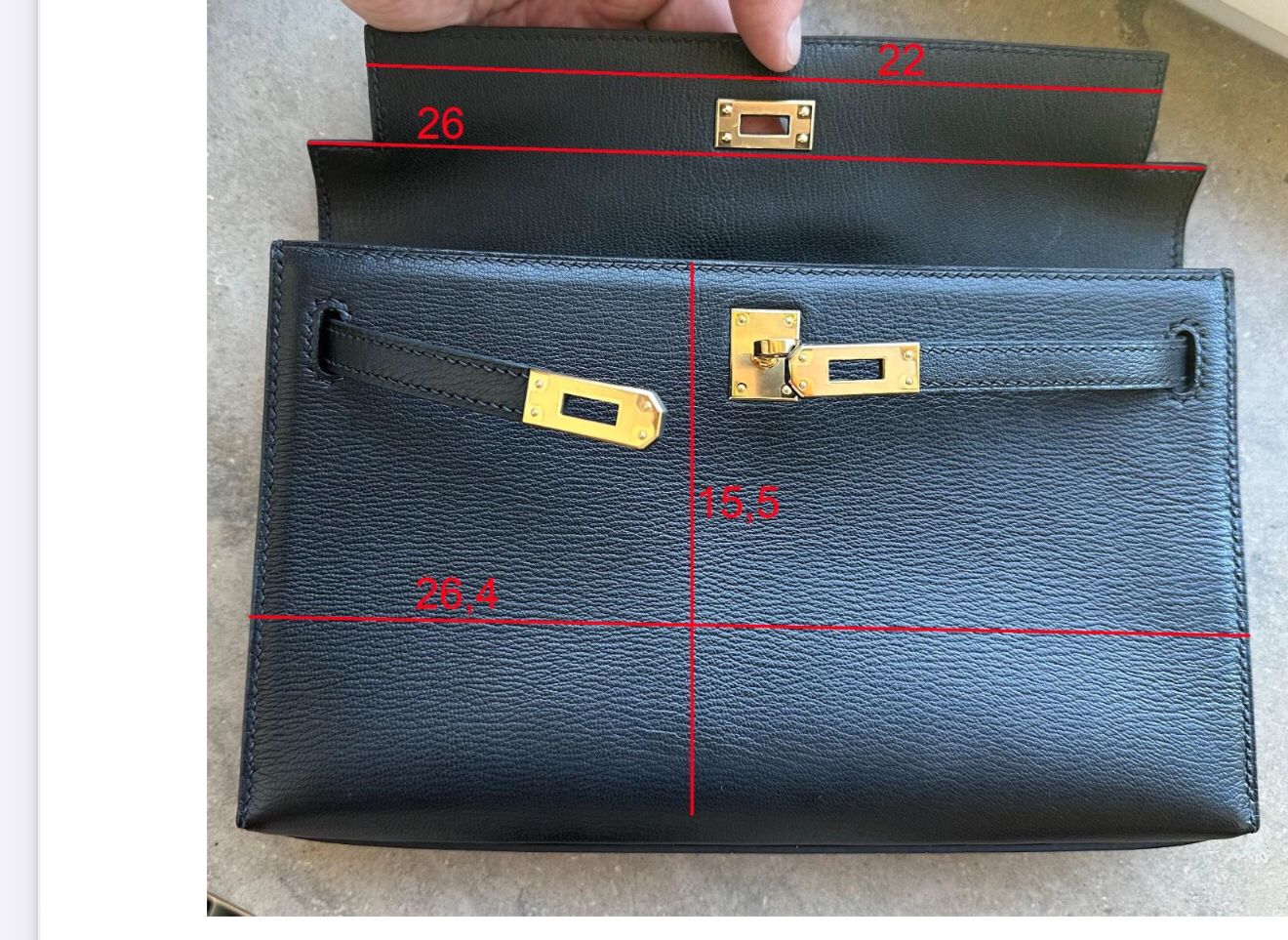 Calfskin leather top handle satchel handbag by Rossie Viren with structured design and elegant carry handle.