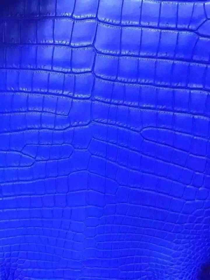 Crocodile skin belly leather in a vibrant colorway, showcasing textured crocodile pattern on a luxury handbag or belt.