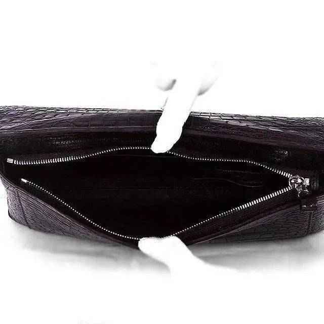 Rossie Viren crocodile belly skin large clutch bag with textured, glossy surface and sleek design, perfect for elegant occasions.