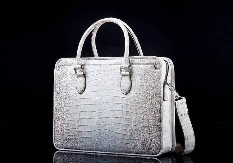White crocodile belly leather briefcase handbag by Rossie Viren with textured crocodile pattern and sturdy handle.