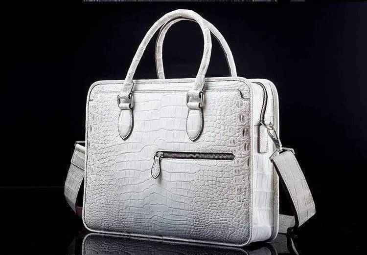 White crocodile belly leather briefcase handbag by Rossie Viren with sleek, structured design and top handle for professional style.