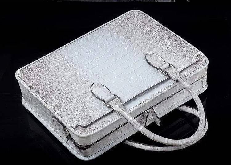 White crocodile belly leather briefcase handbag by Rossie Viren with sleek design and textured crocodile pattern.