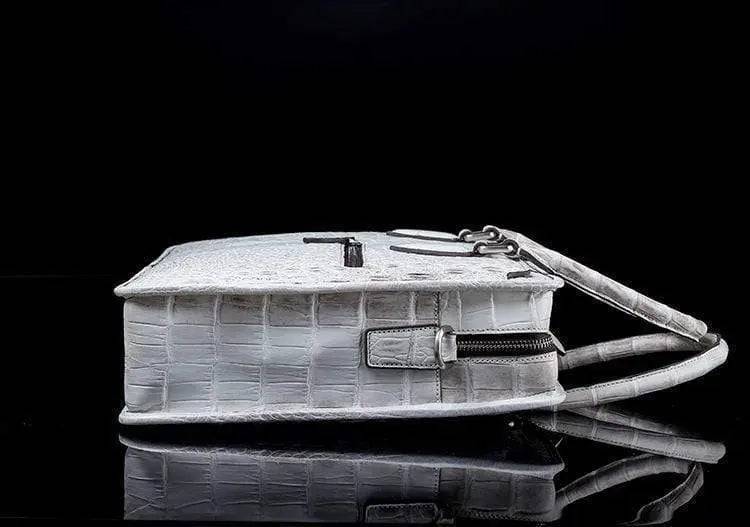 White crocodile belly leather briefcase handbag by Rossie Viren, featuring textured crocodile pattern and sturdy handle.