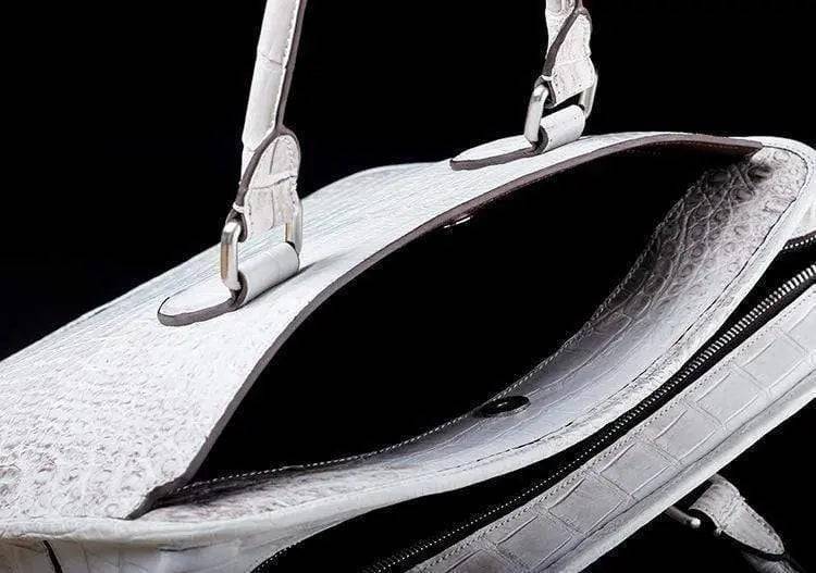 White crocodile belly leather briefcase handbag by Rossie Viren showing textured crocodile pattern and structured design.