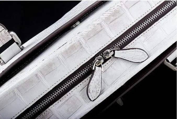 White crocodile belly leather briefcase handbag by Rossie Viren, featuring a sleek, textured crocodile pattern and sturdy handle.