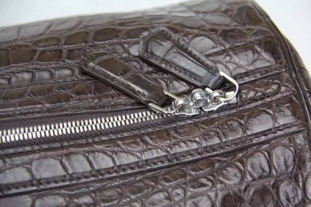 Rossie Viren crocodile belly leather travel duffel bag in super medium size with sturdy handles and textured crocodile pattern.
