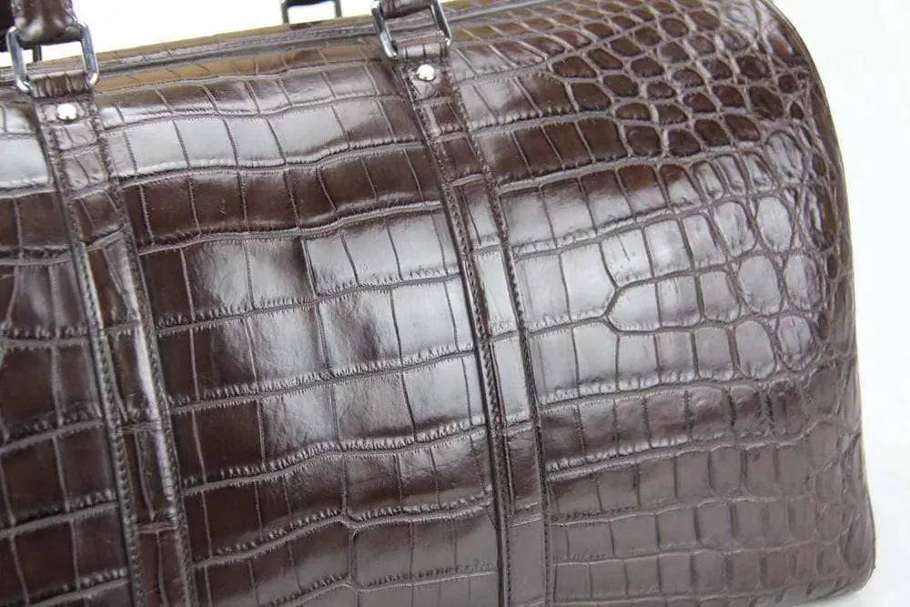 Rossie Viren crocodile belly leather travel duffel bag, medium size, with sturdy handles and textured crocodile pattern.