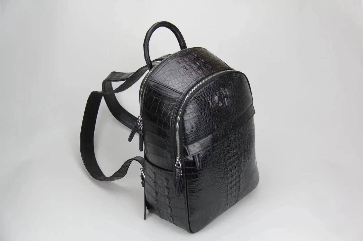 Rossie Viren crocodile leather backpack handbag with sleek design and textured crocodile pattern, featuring adjustable straps and top handle.