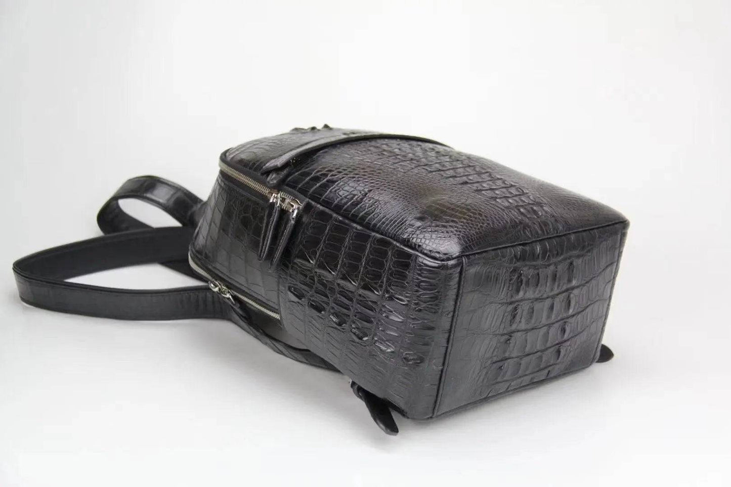 Rossie Viren crocodile leather backpack handbag with sleek design, sturdy straps, and textured crocodile pattern.