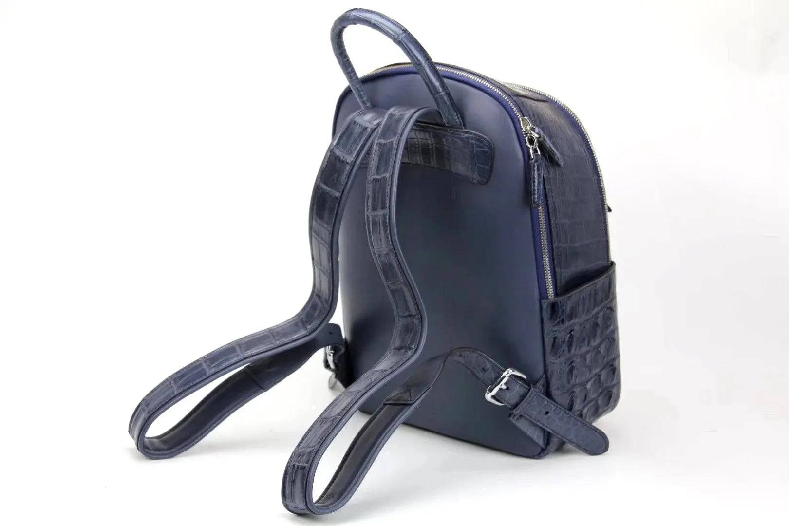 Rossie Viren crocodile leather backpack handbag with a sleek, textured design and adjustable straps on a neutral background.