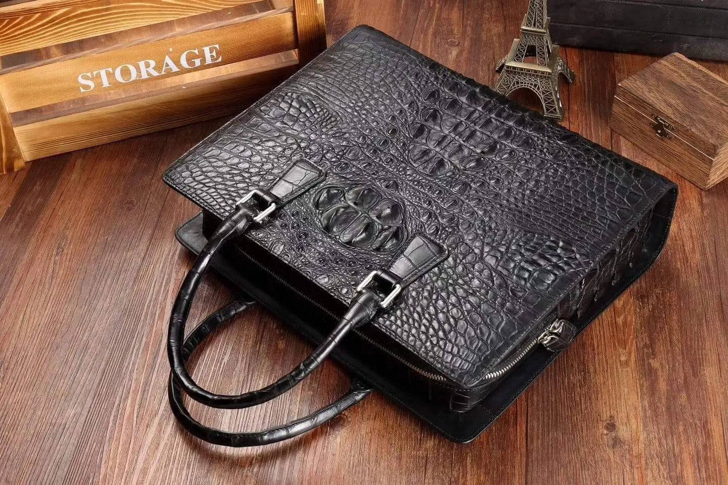 Rossie Viren crocodile leather briefcase handbag with sleek design and sturdy handles on a plain background.