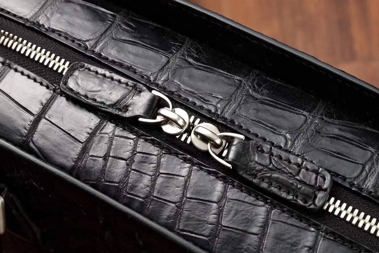 Rossie Viren crocodile leather briefcase handbag with sturdy handles and sleek design, perfect for professional use.