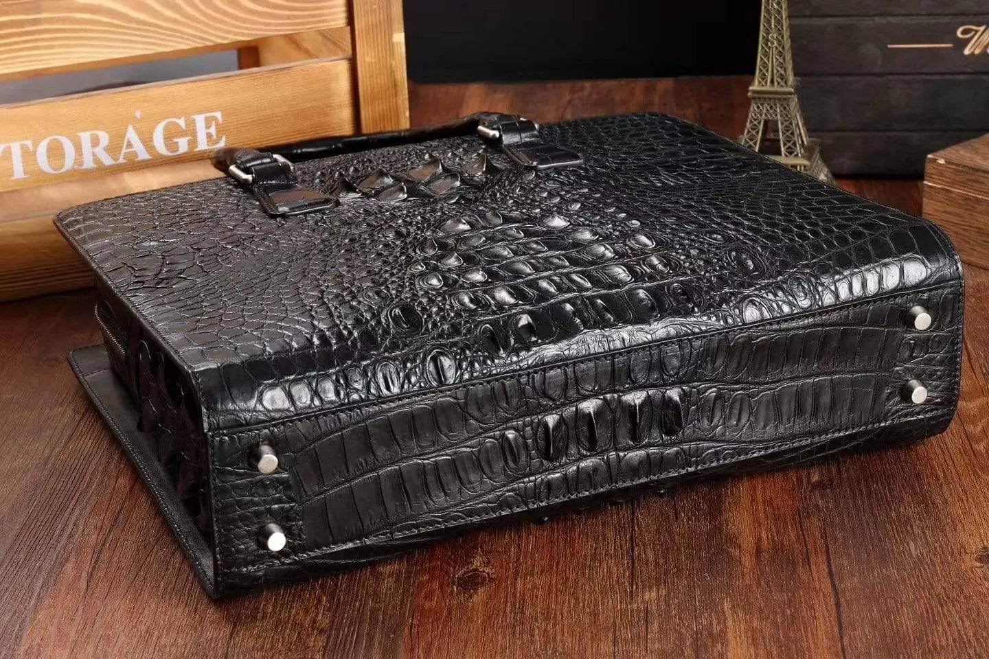 Rossie Viren crocodile leather briefcase handbag with polished metal accents and a sturdy handle, showcasing luxurious textured leather.