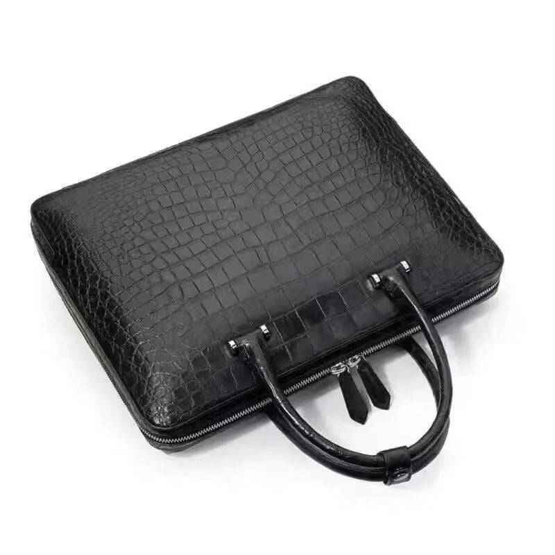 Black crocodile leather briefcase handbag by Rossie Viren, featuring a sleek, textured exterior and sturdy handles.