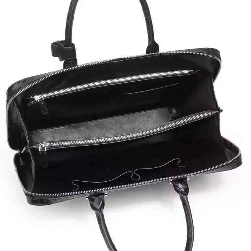 Black crocodile leather briefcase handbag by Rossie Viren with a sleek, textured exterior and sturdy handles.