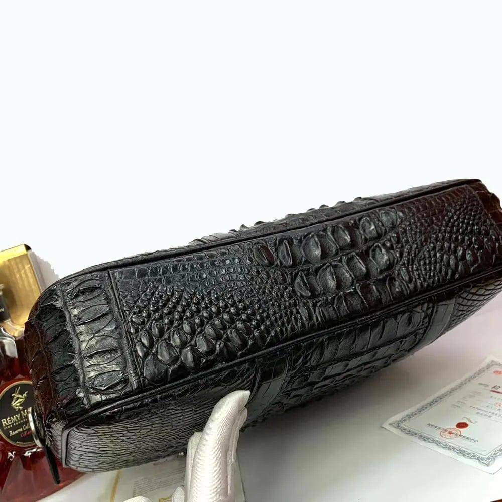 Large crocodile leather briefcase handbag by Rossie Viren with sturdy handles and elegant textured surface.