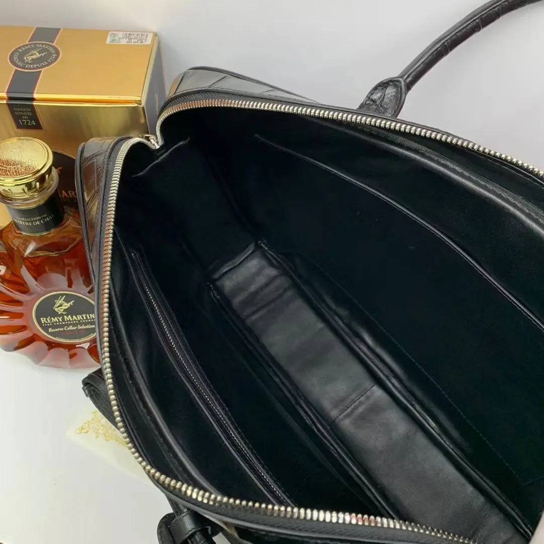 Large crocodile leather briefcase handbag by Rossie Viren with polished metal hardware and sturdy top handle.