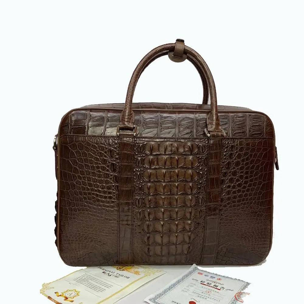 Large crocodile leather briefcase handbag by Rossie Viren with sturdy handles and a sleek, polished finish.