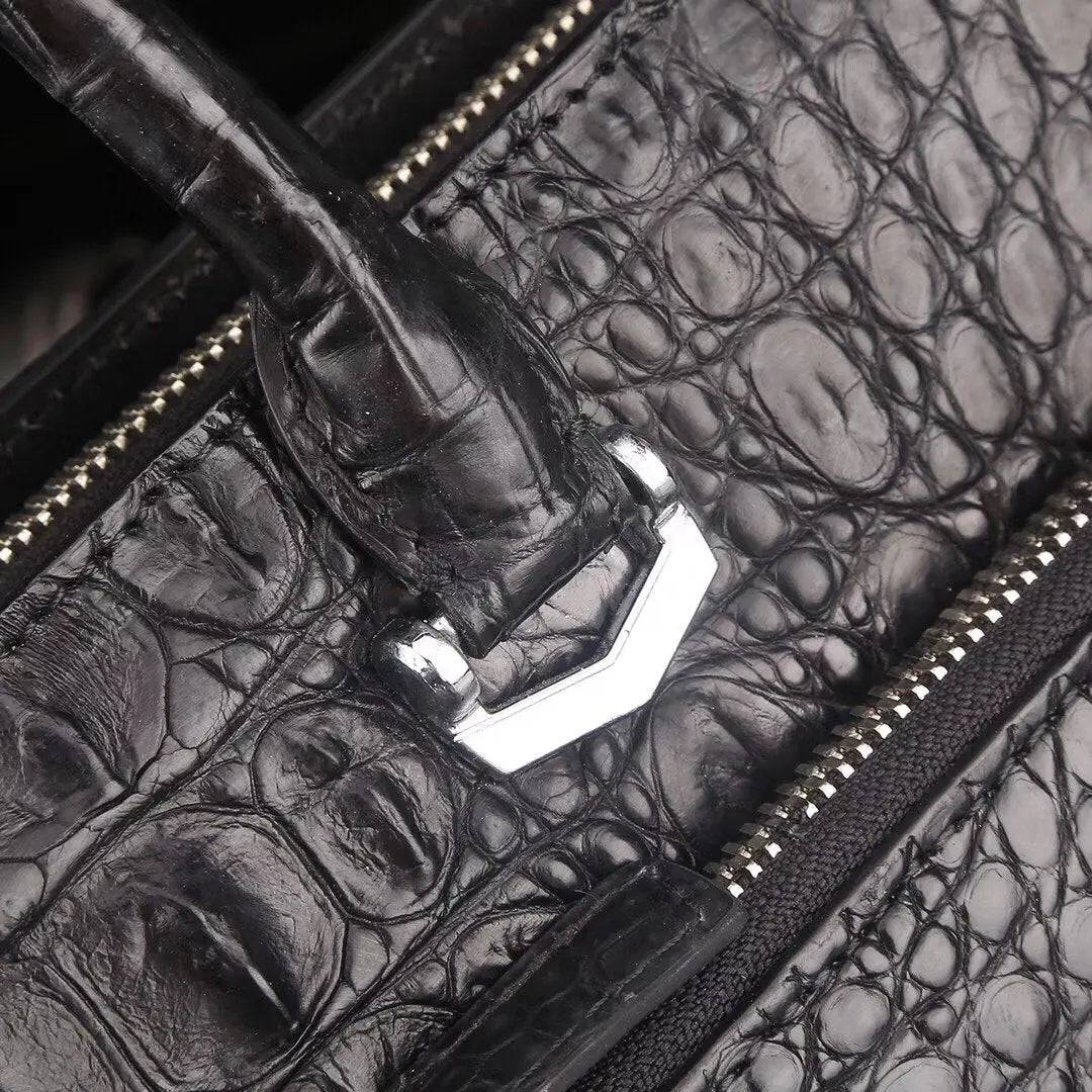 Crocodile leather briefcase laptop handbag by Rossie Viren, featuring a structured design with handles and a sleek, polished finish.
