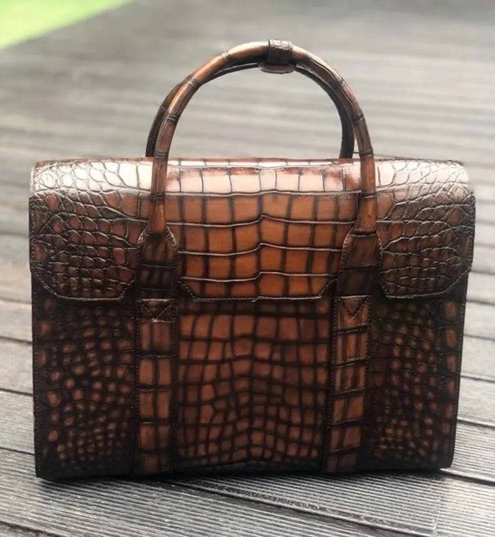 Vintage brown crocodile leather briefcase handbag by Rossie Viren with textured pattern and sturdy handle.