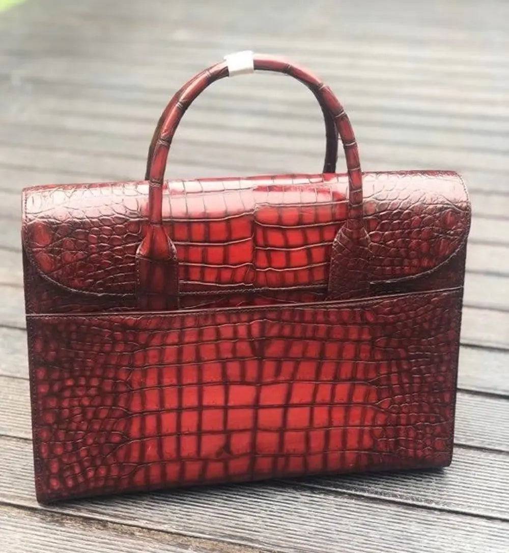 Vintage brown crocodile leather briefcase handbag by Rossie Viren, showing textured crocodile pattern and sturdy handles.
