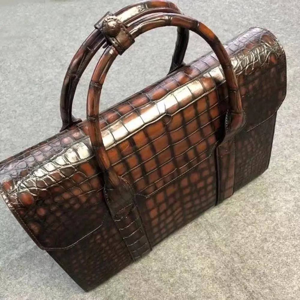 Vintage brown crocodile leather briefcase handbag by Rossie Viren with textured, structured design and sturdy handle.