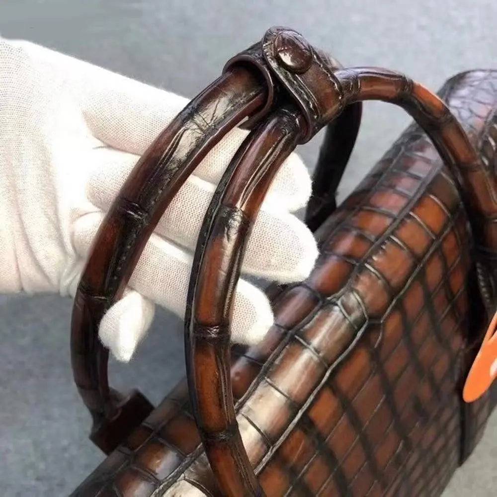 Vintage brown crocodile leather briefcase handbag by Rossie Viren with sturdy handles and textured crocodile pattern.