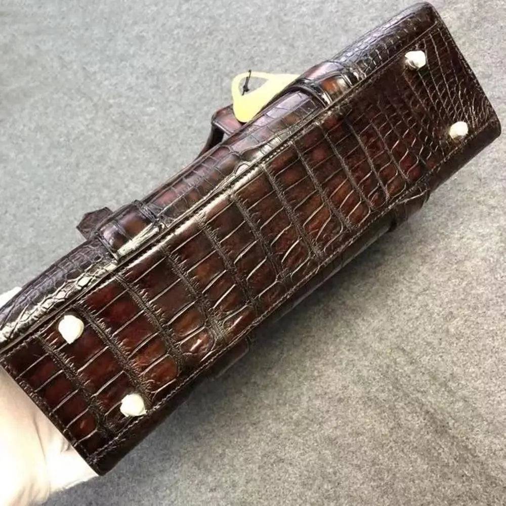 Vintage brown crocodile leather briefcase handbag by Rossie Viren with textured surface and sturdy handle.