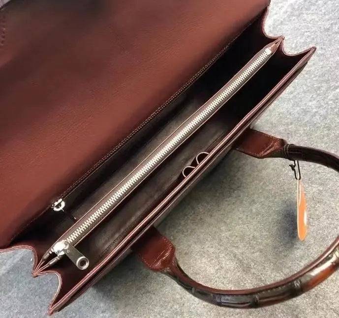 Vintage brown crocodile leather briefcase handbag by Rossie Viren, featuring textured surface and sturdy handle.