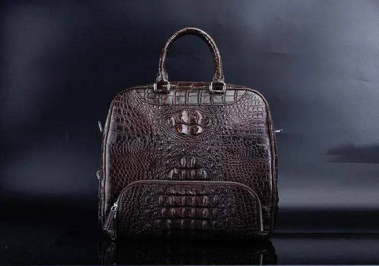 Rossie Viren crocodile leather duffel travel bag in rich brown with sturdy handles and zipper closure.