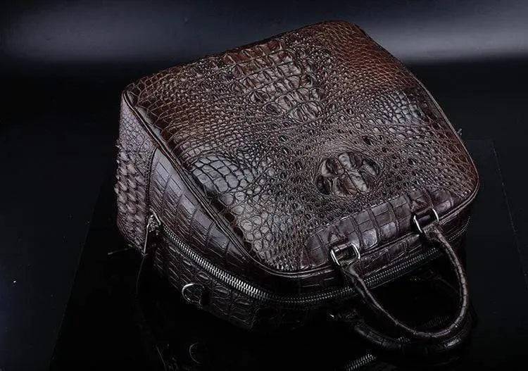 Brown crocodile leather duffel travel bag by Rossie Viren, featuring sturdy handles and a spacious interior for travel essentials.