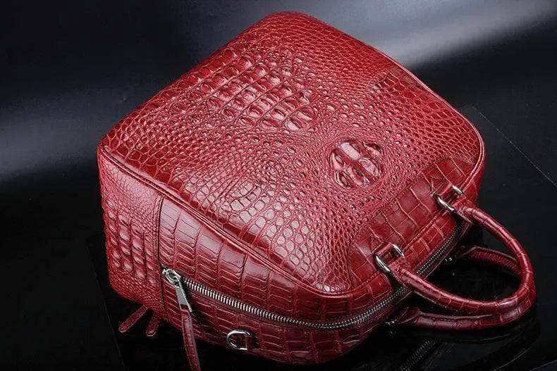 Red crocodile leather duffel travel bag by Rossie Viren, showcasing a spacious handbag with textured crocodile pattern and sturdy handles.