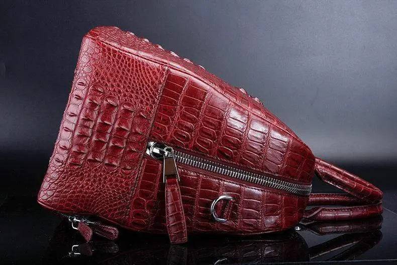 Red crocodile leather duffel travel bag by Rossie Viren, showcasing its textured surface and spacious handbag design.