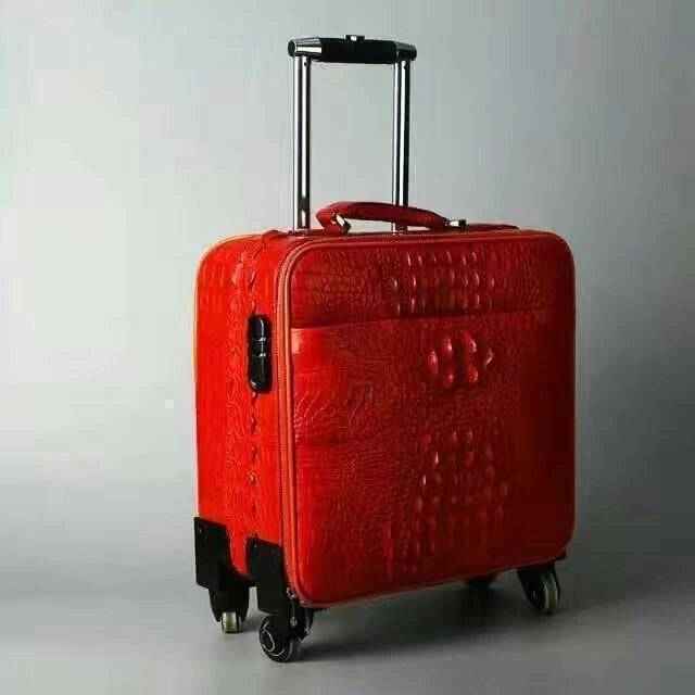 Rossie Viren crocodile leather trolley case with a textured crocodile pattern, sturdy handle, and secure latches for travel.