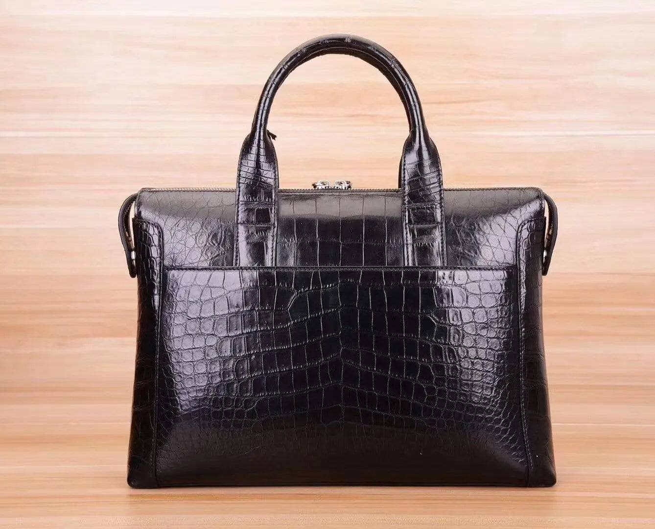 Black crocodile and alligator men's shoulder briefcase bag by Rossie Viren, featuring textured leather and sturdy handles.