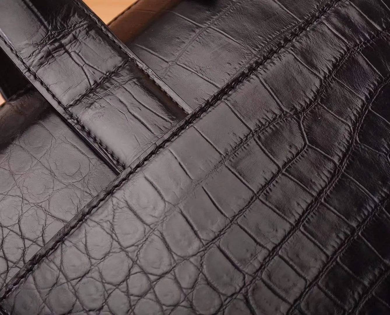 Black crocodile and alligator men's briefcase shoulder bag by Rossie Viren, featuring textured leather and sturdy carry straps.