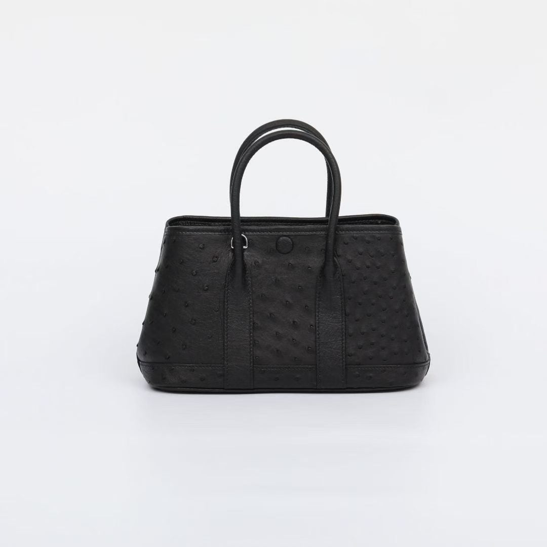 Genuine ostrich skin leather small tote bag by Rossie Viren, featuring textured surface and sturdy handles.