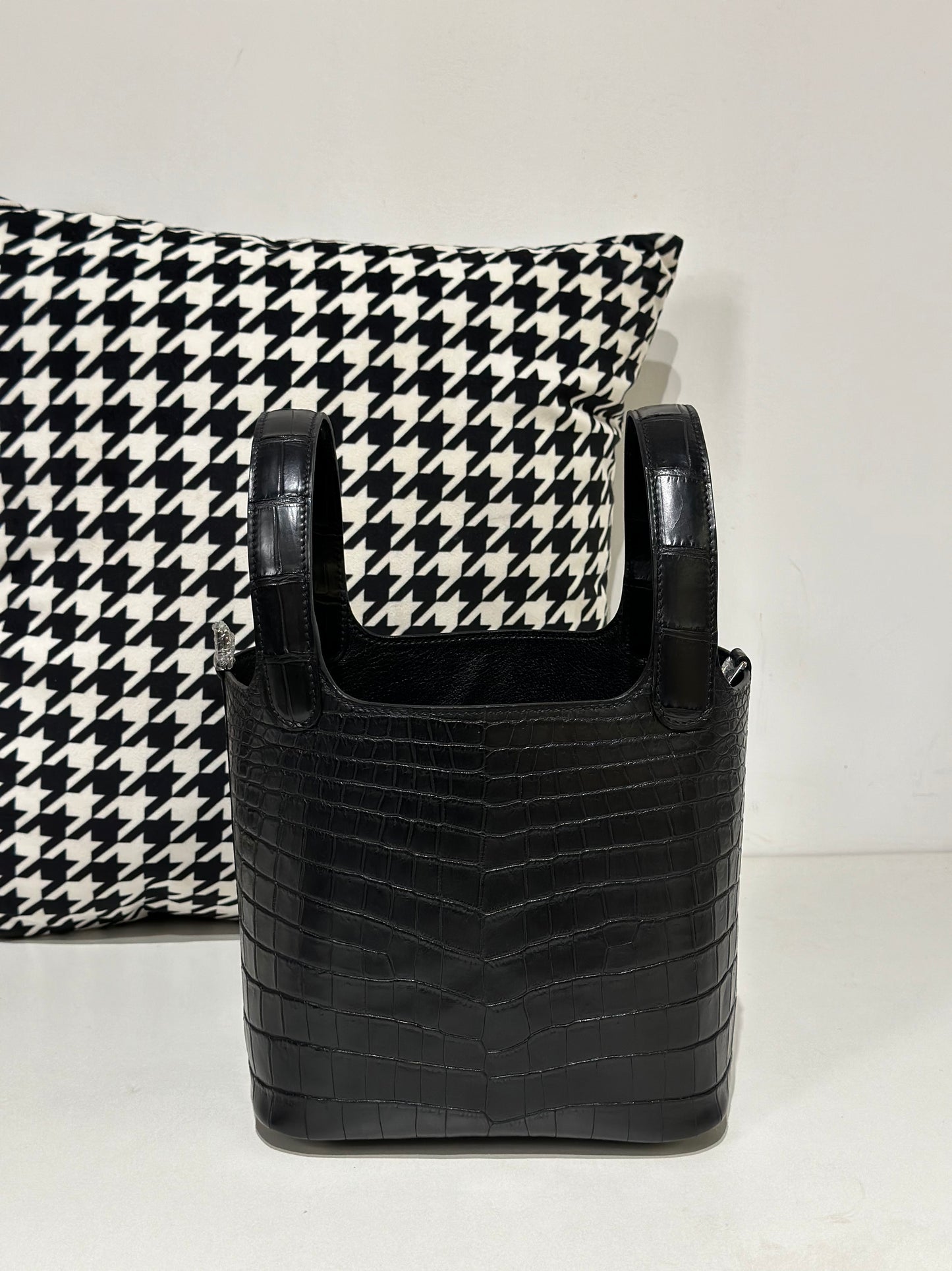 Women's black croc-embossed leather crossbody handbag by Rossie Viren, featuring a compact design and textured crocodile skin finish.