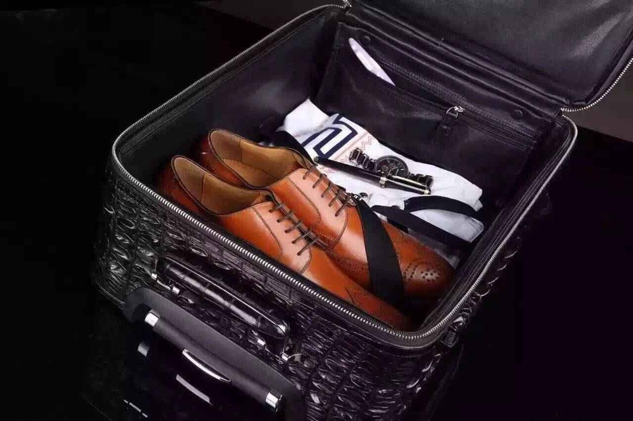Genuine crocodile leather laptop trolley luggage case by Rossie Viren with sturdy wheels and sleek travel luggage design.